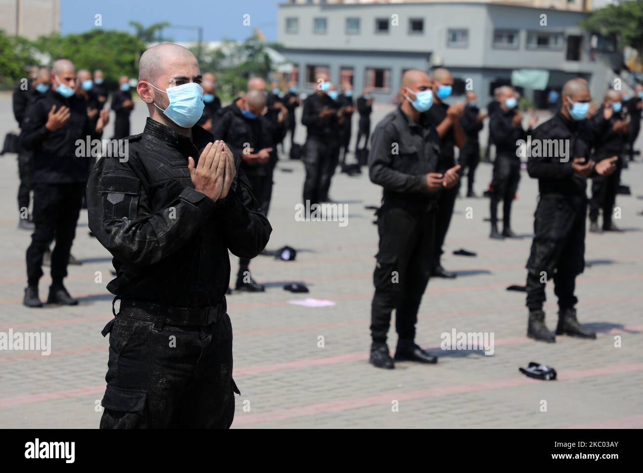 Palestinian police recruits loyal to Hamas pray after a training session to new police forces to be deployed in the emergency plan to support fighting the spread of the corona virus disease (COVID-19), in Gaza City September 17, 2020. (Photo by Majdi Fathi/NurPhoto) Stock Photo