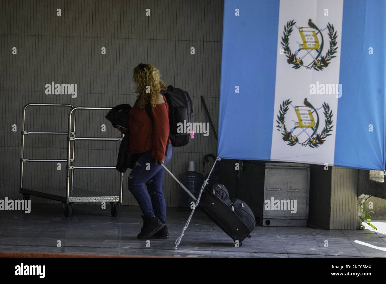 A traveler walks with her bags at La Aurora International Airport, in Guatemala City, Guatemala on Friday, September 18. The airport opens its international flight operations, and remained closed for 6 months to prevent the spread of COVID-19. During the pandemic, 84,344 people were infected and 3,076 died. (Photo by Deccio Serrano/NurPhoto) Stock Photo