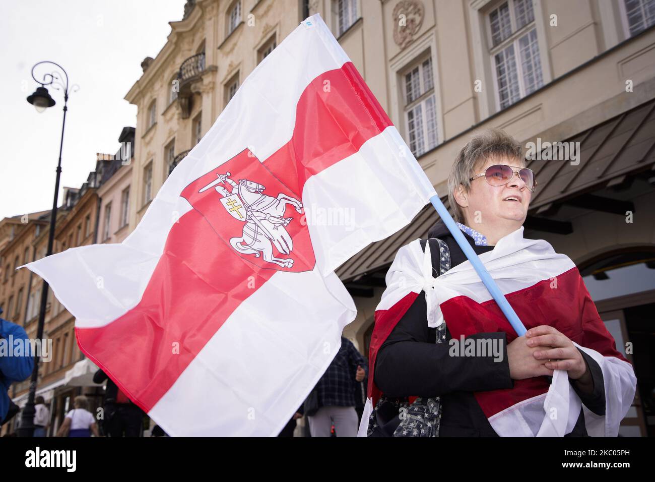 A woman is seen holding the Belarusian White-Red-White flag with the Pogon symbol in Warsaw, Poland on September 19, 2020. Several dozen people, mostly Belarusians took part in a march in central Warsaw to celebrate the first use of the White-Red-White flag in 19 September 1991, the alternative flag that is now a symbol of the Belarusian opposition. (Photo by Jaap Arriens/NurPhoto) Stock Photo