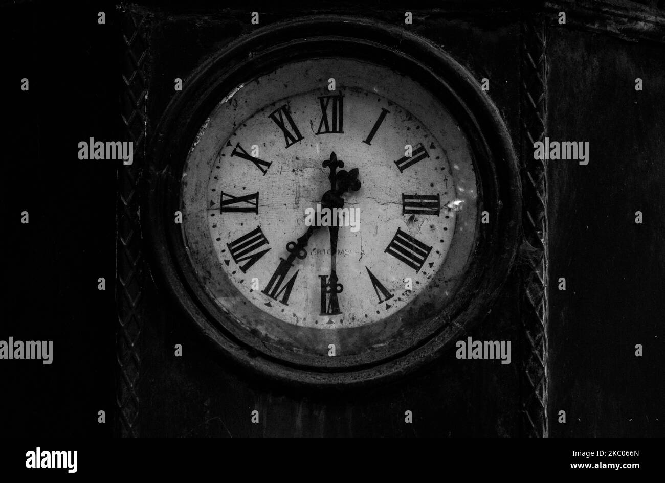 A closeup black and white view of an old clock in public park in Braga