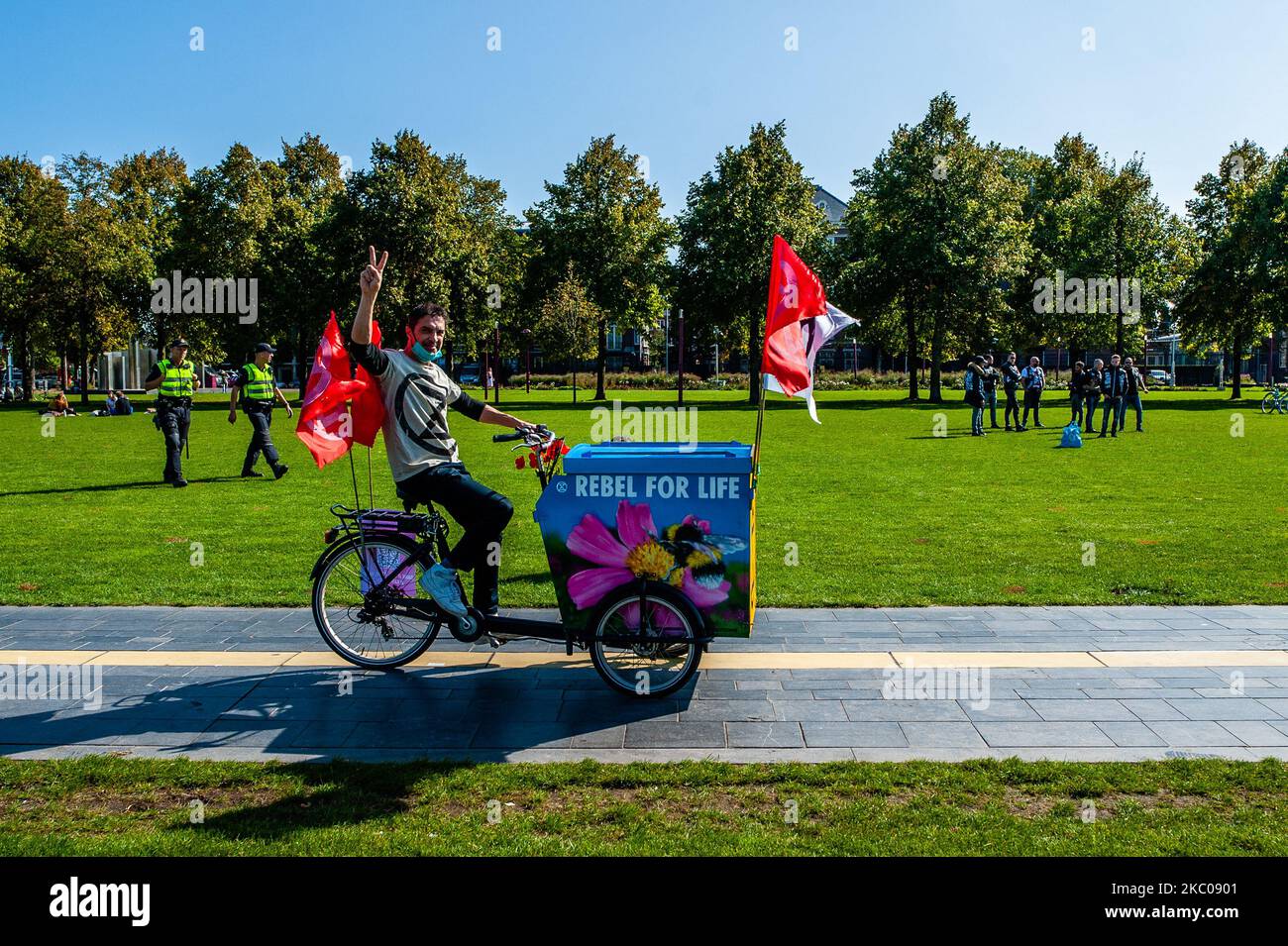 An XR activist is riding a bike with the XR logo on it, during the Extinction Rebellion camp located at the Museumplein, in Amsterdam, on September 19th, 2020. (Photo by Romy Arroyo Fernandez/NurPhoto) Stock Photo