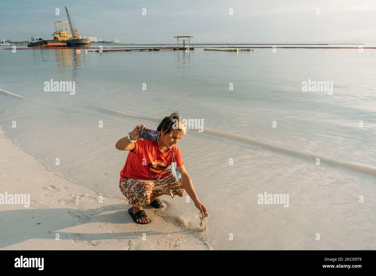 Man fishing at the beach wearing a face mask Stock Photo - Alamy