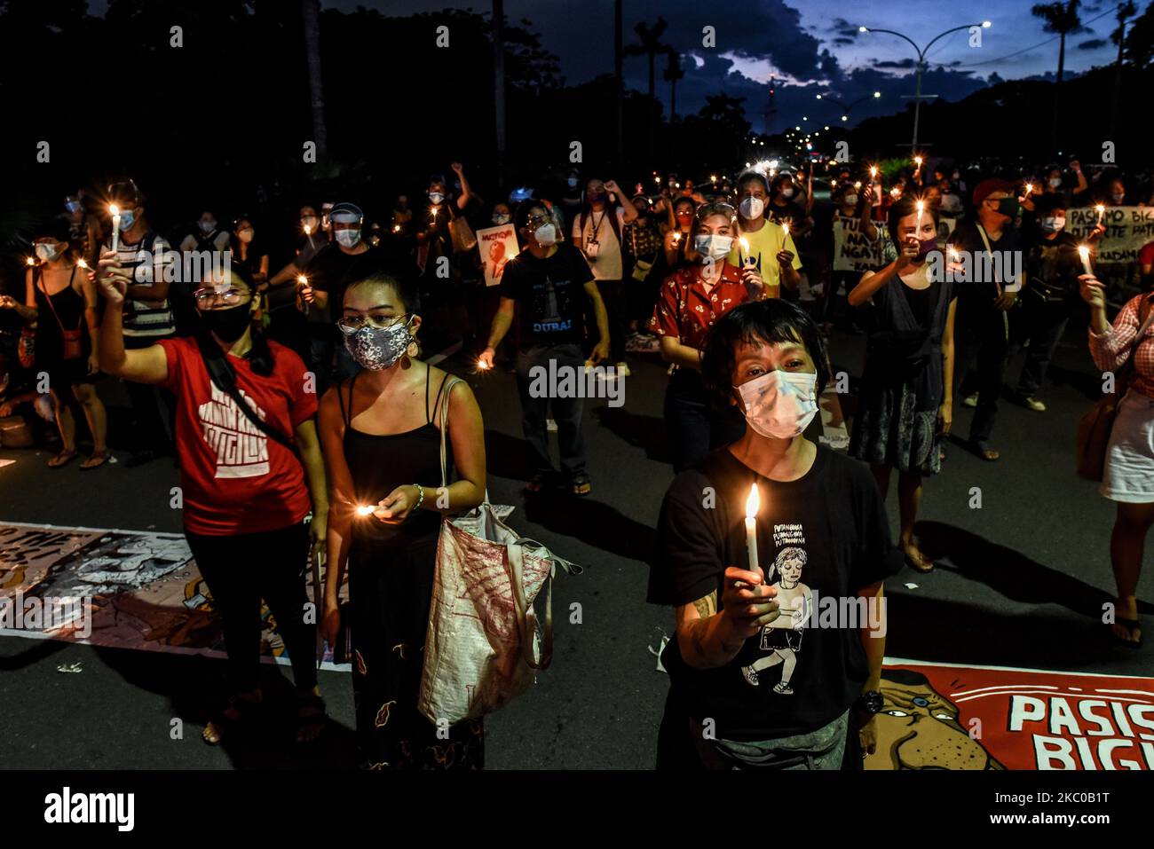 Activists light candles during the 48th anniversary of the Martial Law