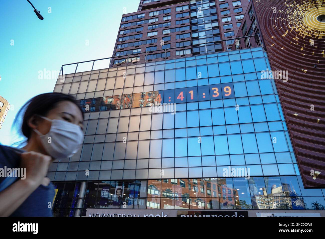 A view of a person wearing a mask passing in front of Union Square
