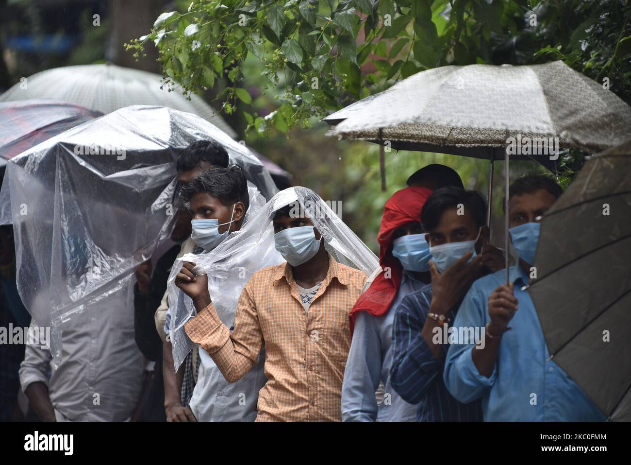 Nepalese people and Indian Migrant workers covering plastics to protect