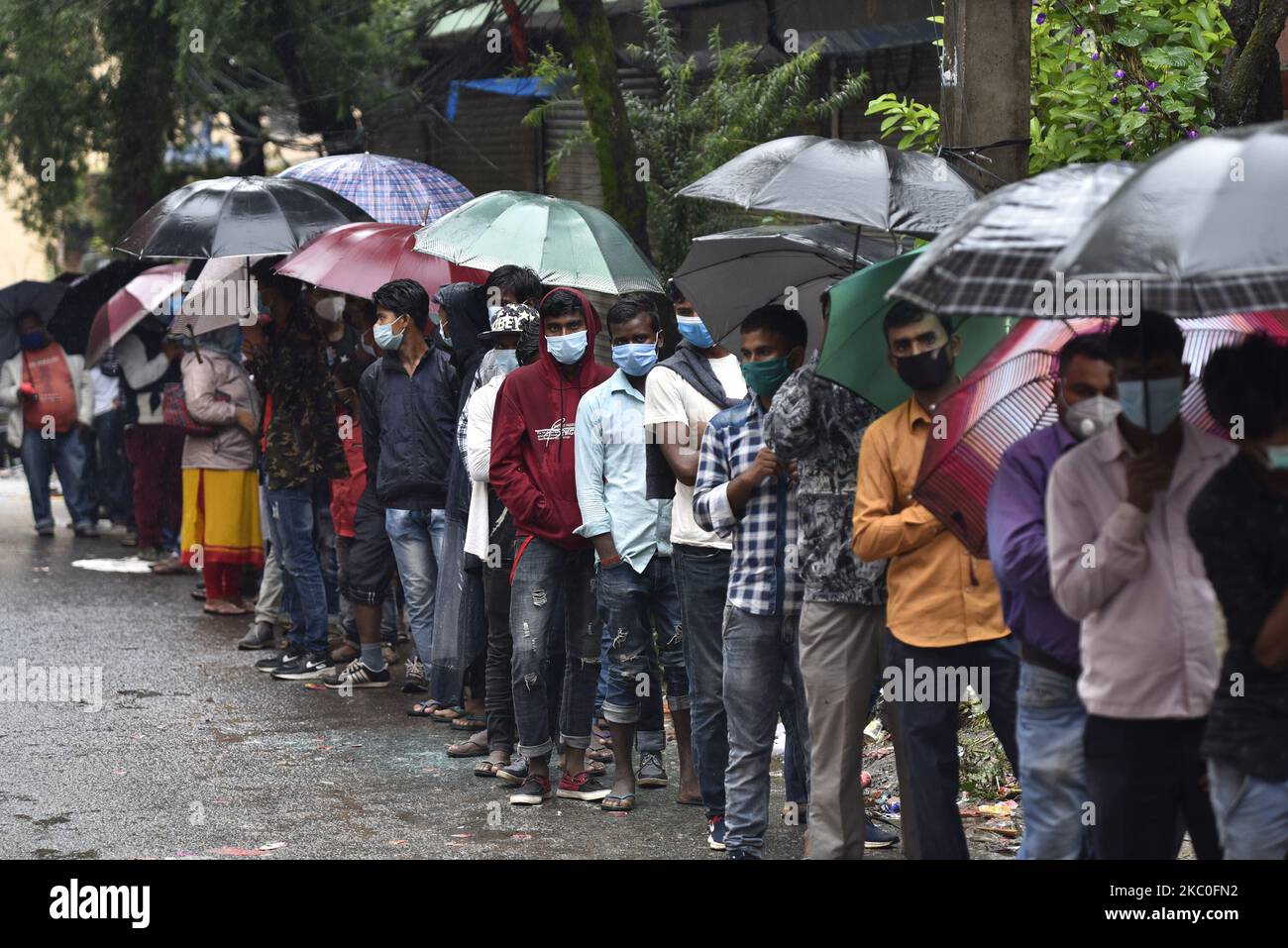 Nepalese people and Indian Migrant workers along with an umbrella