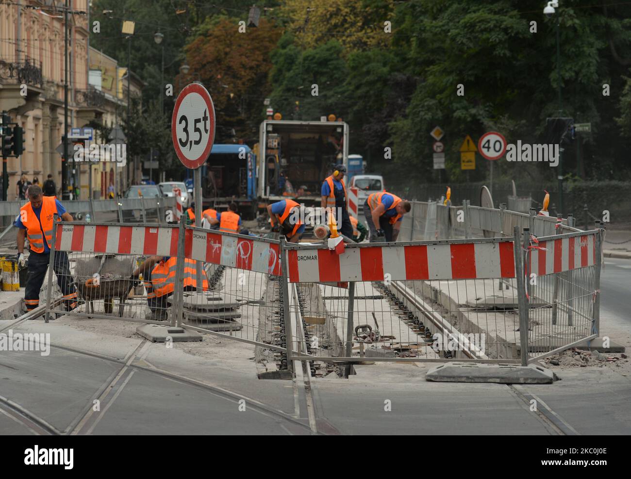 A group of workers repairing tram rails in Krakow's center. The number of COVID-19 infected in Poland is constantly growing, and two days in a row they have the highest number of new cases of COVID. The Health Ministry reported today 1,587 new cases, a new daily record of new cases, and 23 deaths. On September 25, 2020, in Krakow, Poland. (Photo by Artur Widak/NurPhoto) Stock Photo