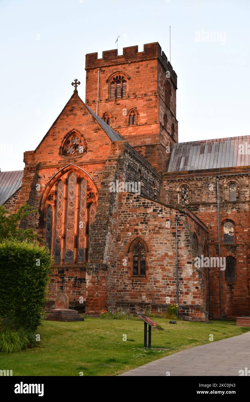 Carlisle Cathedral built from local red sandstone glowing in the early evening sun. First founded as a Norman Priory Church in 1122, becoming a cathed Stock Photo