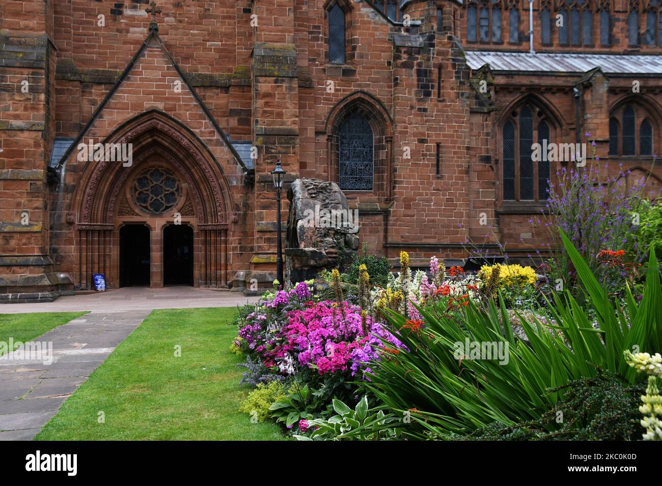 A view towards the south porch of Carlisle Cathedral with remains of previous ecclesiastical buildings in the foreground.Carlisle Cathedral first foun Stock Photo