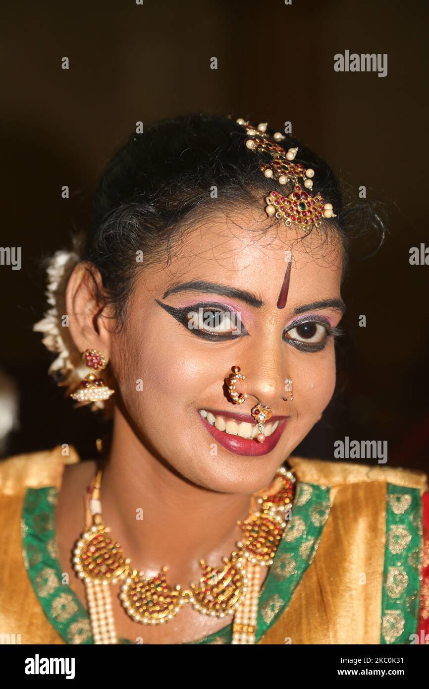 Tamil girl dressed in traditional attire waits to perform a