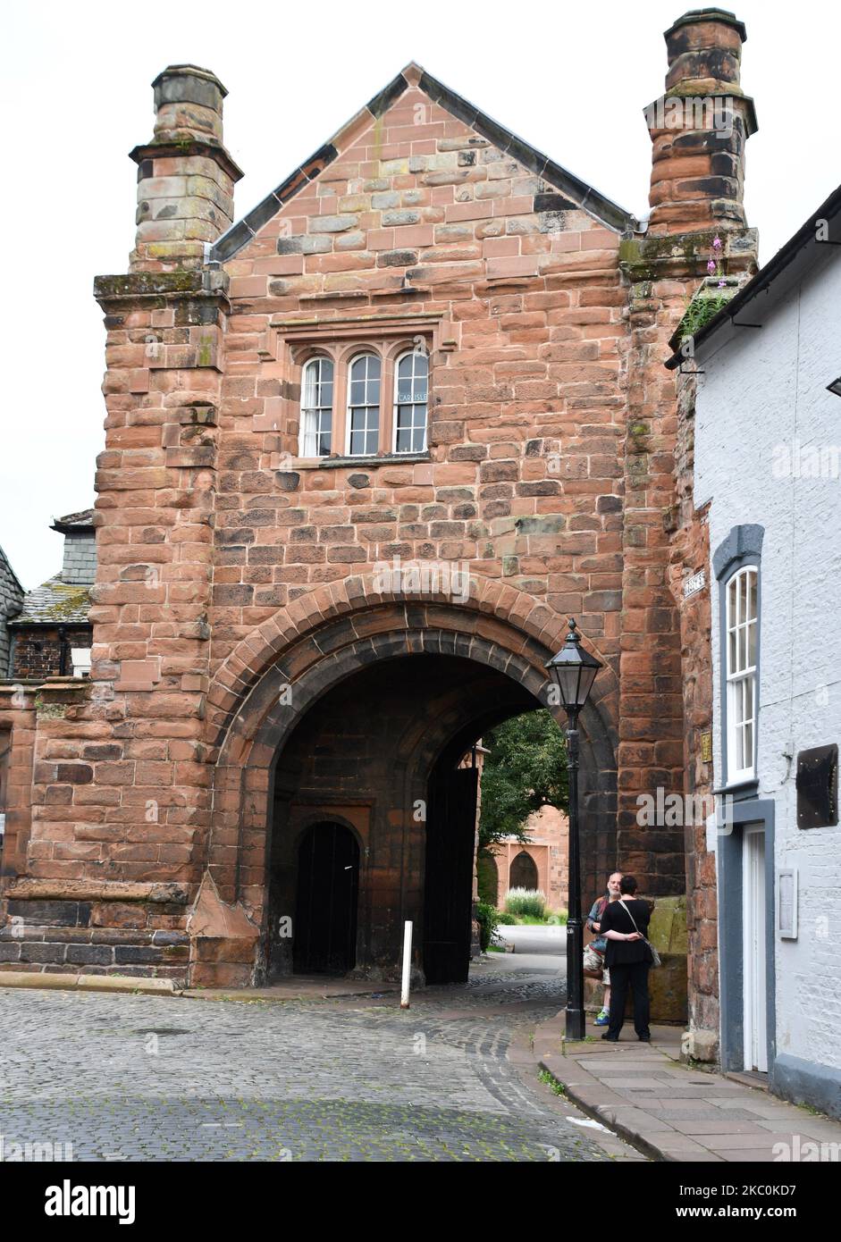 Carlisle Cathedral precinct gatehouse where Paternastor Row and Abbey Street meet in the centre of the city. Stock Photo