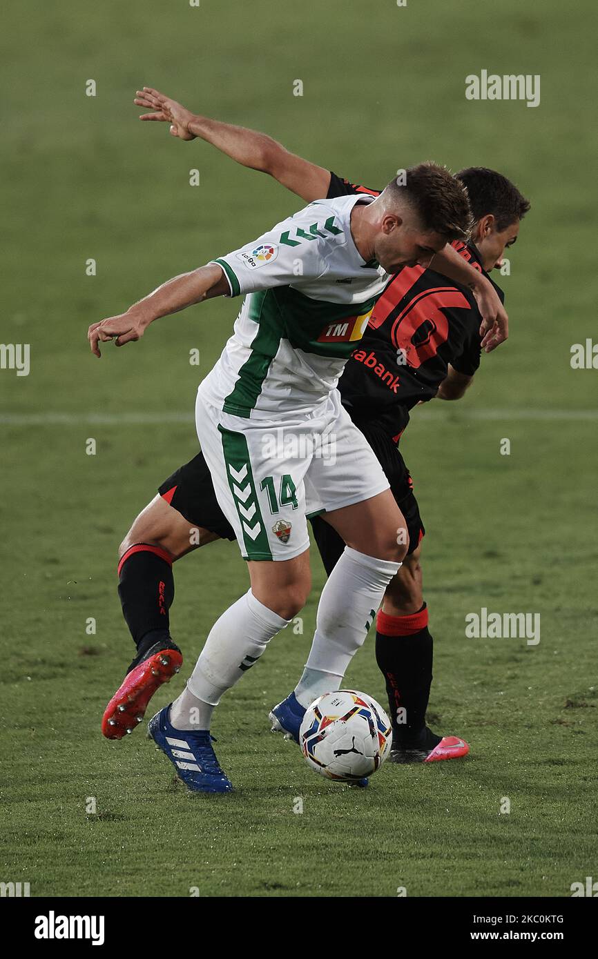 Raul Guti of Elche and Ander Guevara of Real Sociedad compete for the ball during the La Liga Santader match between Elche CF and Real Sociedad at Estadio Martinez Valero on September 27, 2020 in Elche, Spain. (Photo by Jose Breton/Pics Action/NurPhoto) Stock Photo