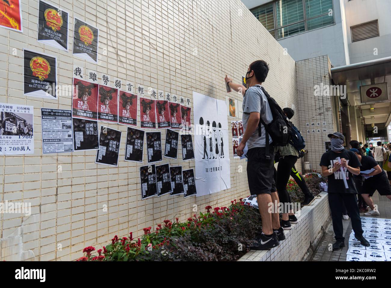 Protesters stick posters on a wall in Wanchai, Hong Kong, China, on 28 Sep 2019. (Photo by Marc Fernandes/NurPhoto) Stock Photo