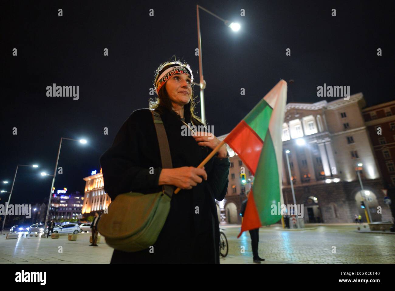 A protester holds a Bulgarian national flag on the 82nd day of anti-government protest in Sofia, in the Triangle of Power (the space between the buildings of the Presidency, the National Assembly and the Council of Ministers). For nearly three months people have been taking part in daily protests against corruption, demanding the resignation of the government of Boyko Borissov, in power since 2009. On Monday, September 28, 2020, in Sofia, Bulgaria. (Photo by Artur Widak/NurPhoto) Stock Photo