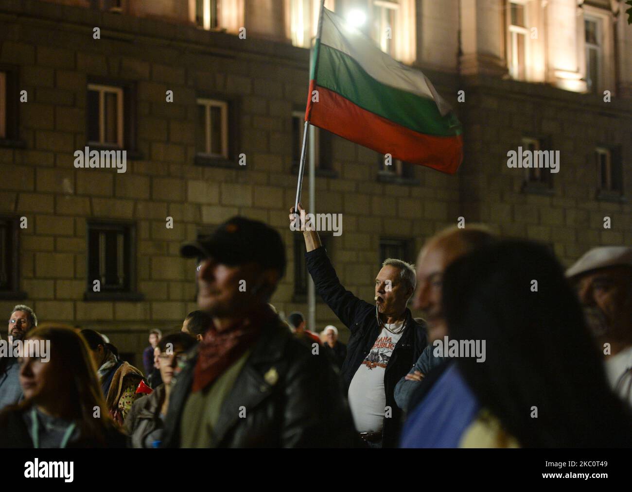 A protester waves a Bulgarian national flag and blow whistle on the 82nd day of anti-government protest in Sofia, in the Triangle of Power (the space between the buildings of the Presidency, the National Assembly and the Council of Ministers). For nearly three months people have been taking part in daily protests against corruption, demanding the resignation of the government of Boyko Borissov, in power since 2009. On Monday, September 28, 2020, in Sofia, Bulgaria. (Photo by Artur Widak/NurPhoto) Stock Photo