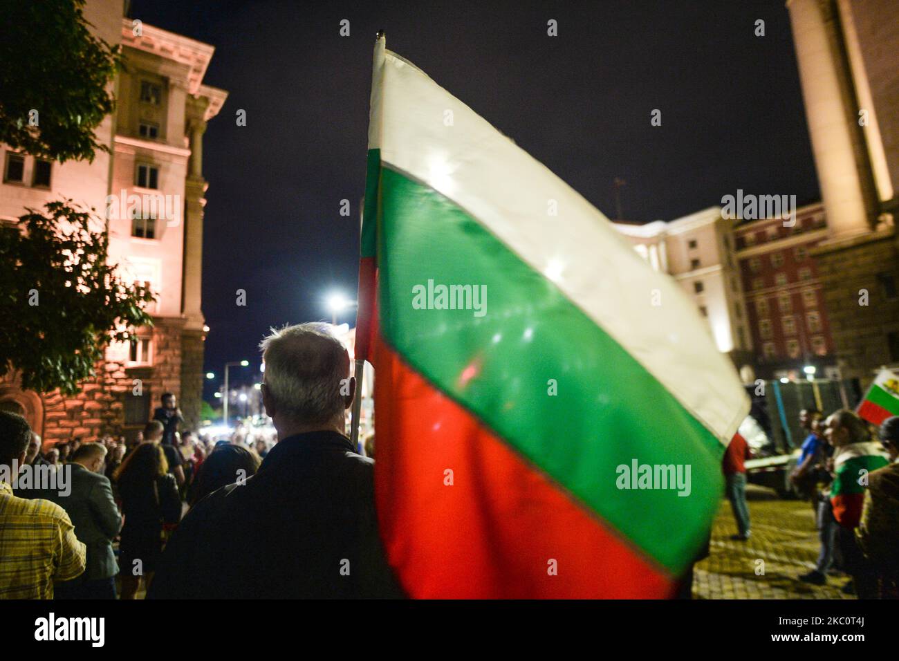 A protester holds a Bulgarian national flag on the 82nd day of anti-government protest in Sofia, in the Triangle of Power (the space between the buildings of the Presidency, the National Assembly and the Council of Ministers). For nearly three months people have been taking part in daily protests against corruption, demanding the resignation of the government of Boyko Borissov, in power since 2009. On Monday, September 28, 2020, in Sofia, Bulgaria. (Photo by Artur Widak/NurPhoto) Stock Photo