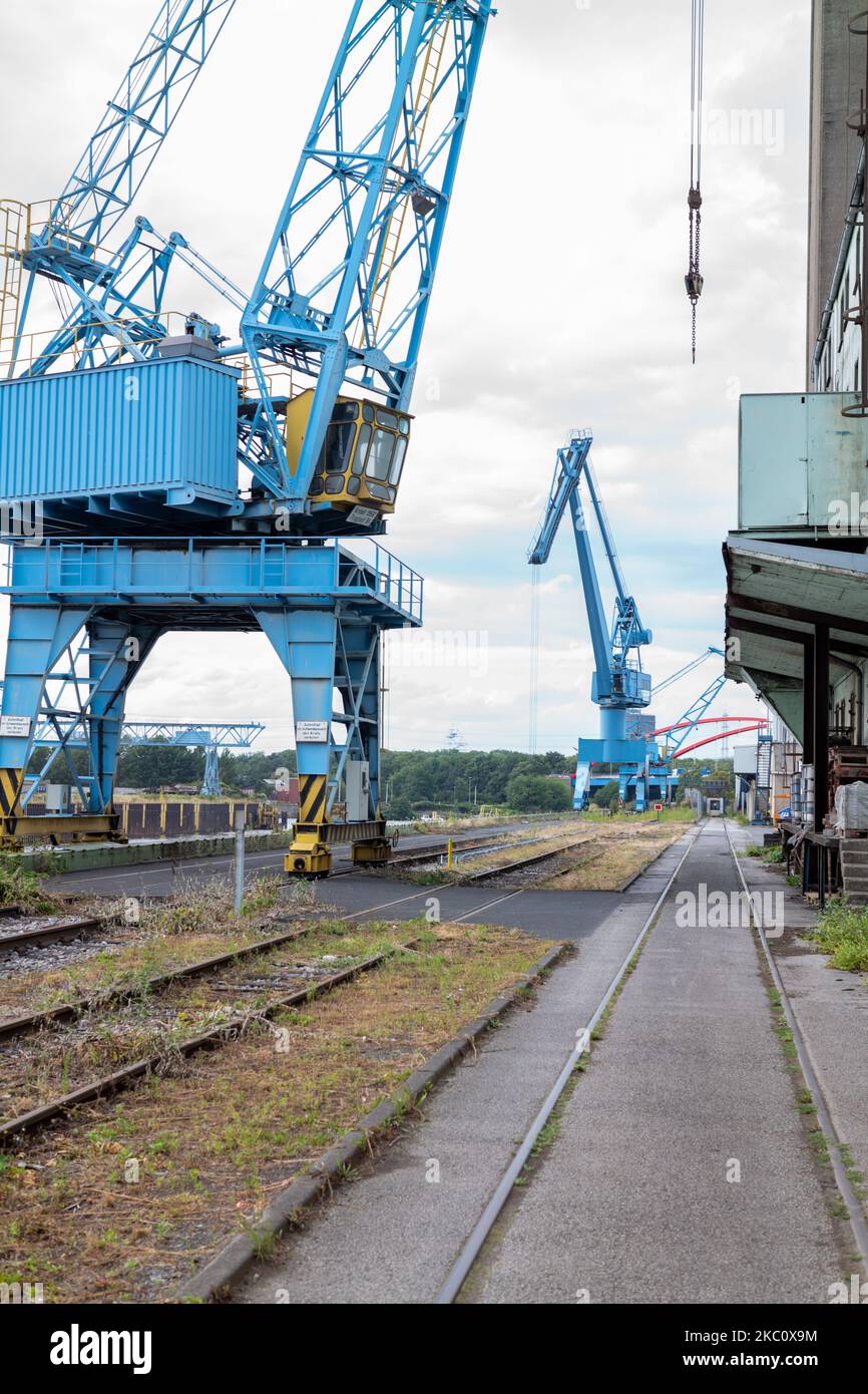 A vertical shot of blue crane machines working on a railway Stock Photo