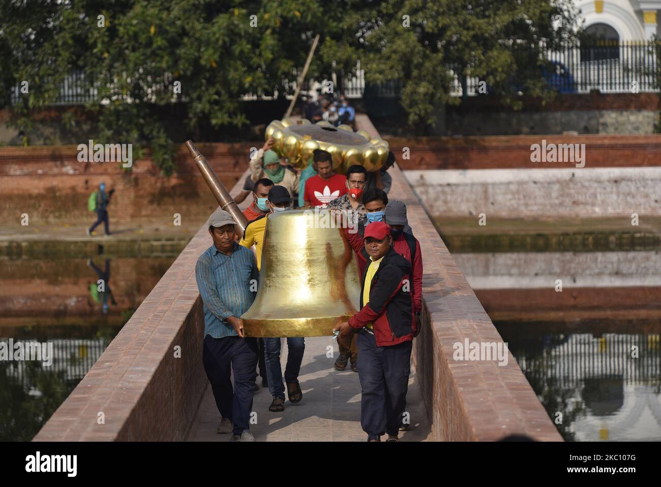 Nepalese people carrying pinnacle to put on the top of Rani Pokhari's Bal Gopaleshwar temple after the reconstruction at Kathmandu, Nepal on Thursday, October 1, 2020. The temple which destroyed during 2015 earthquake and recently rebuilt in the original Malla-era Shikar style. (Photo by Narayan Maharjan/NurPhoto) Stock Photo