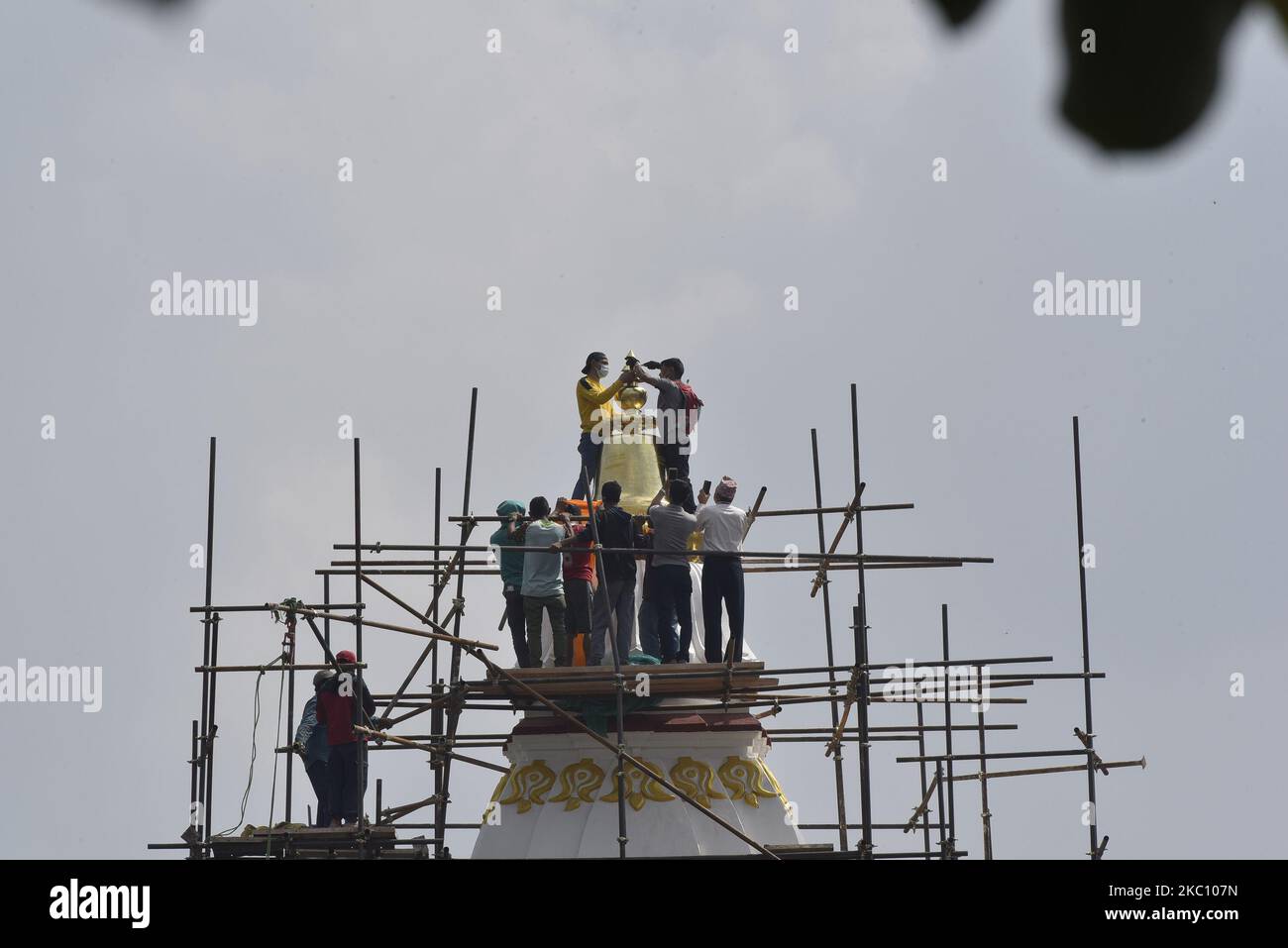 Nepalese people installing pinnacle on the top of Rani Pokhari's Bal Gopaleshwar temple after the reconstruction at Kathmandu, Nepal on Thursday, October 1, 2020. The temple which destroyed during 2015 earthquake and recently rebuilt in the original Malla-era Shikar style. (Photo by Narayan Maharjan/NurPhoto) Stock Photo