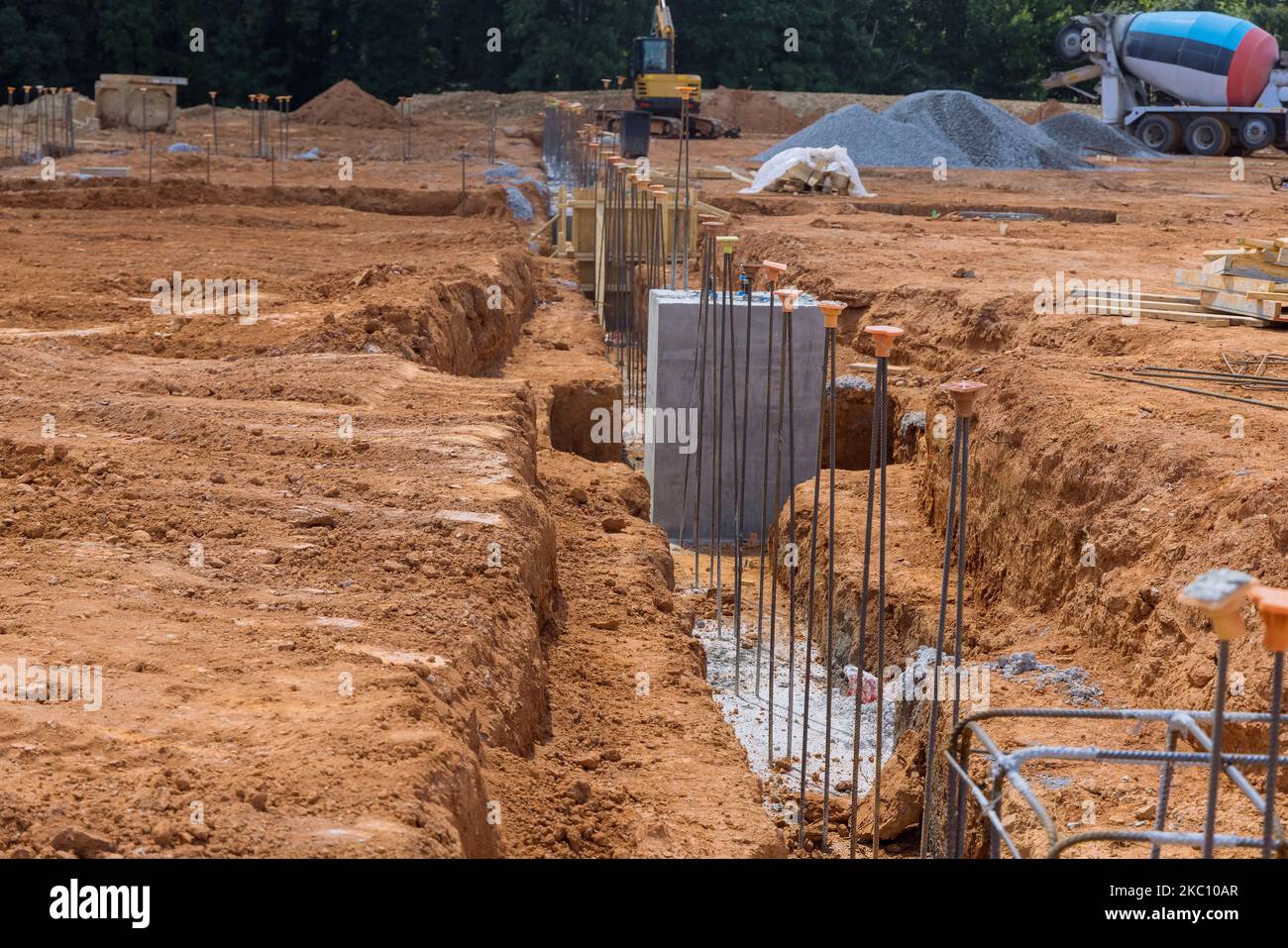 During construction reinforcement with steel bars rebar wires is being placed into trenches for purpose strengthening concrete foundation Stock Photo