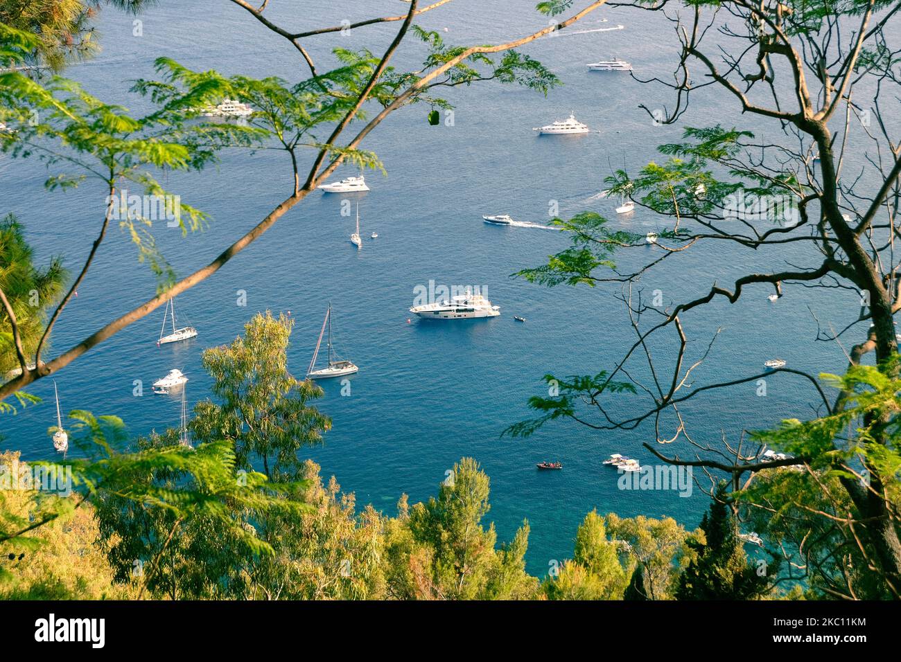 The beautiful view of the white boats and yachts in the blue sea seen ...