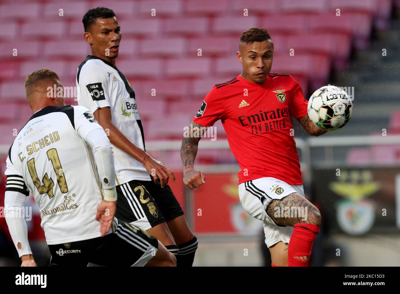 Everton of SL Benfica (R ) vies with Claudio Falcao of SC Farense (C ) and Cassio Scheid(L) during the Portuguese League football match between SL Benfica and SC Farense at the Luz stadium in Lisbon, Portugal on October 4, 2020. (Photo by Pedro FiÃºza/NurPhoto) Stock Photo