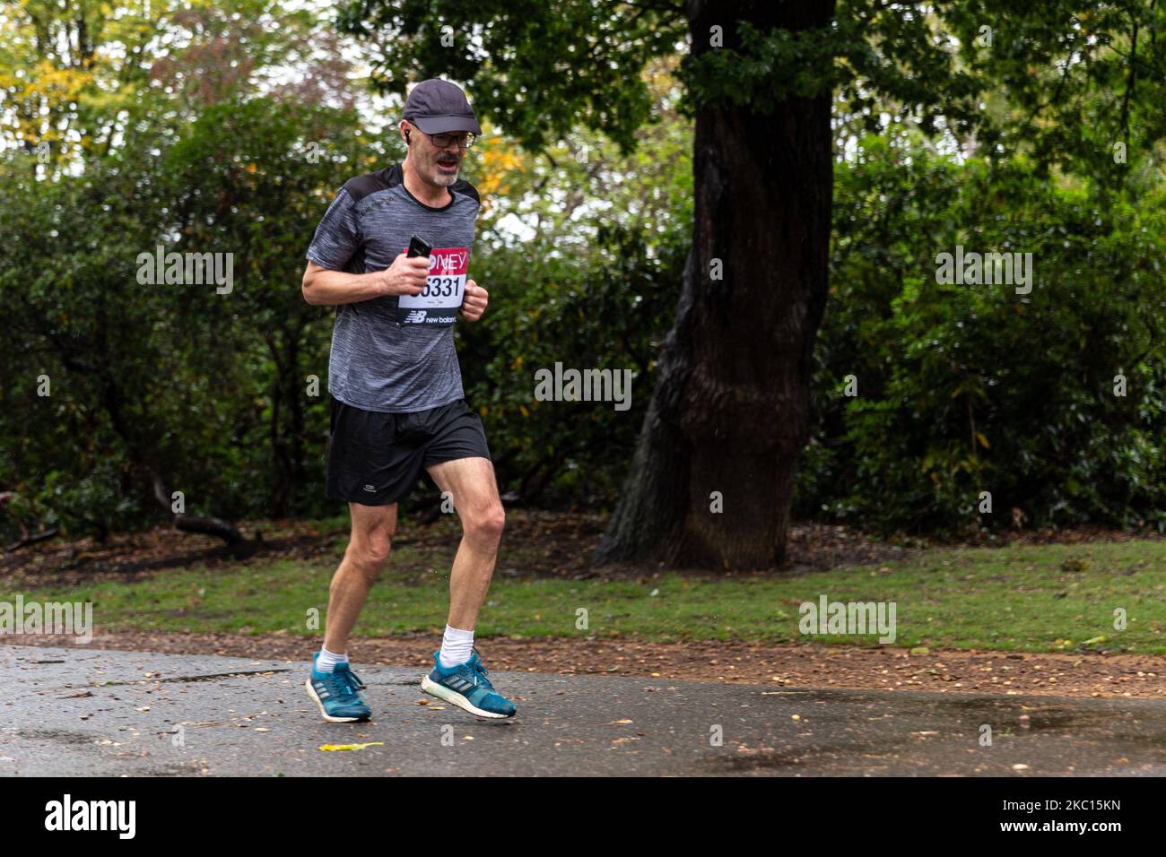 Tim Jackson a participant of Virgin Money Virtual London Marathon is seen running in cold rainy weather in Dulwich Park in South London, England on October 4, 2020. Due to Covid-19 pandemic, the London Marathon for the public was virtual. Participants run in locations of the choice, having a mobile application as a monitoring system. Family and friends often took shorter distances to support the runner. (Photo by Dominika Zarzycka/NurPhoto) Stock Photo