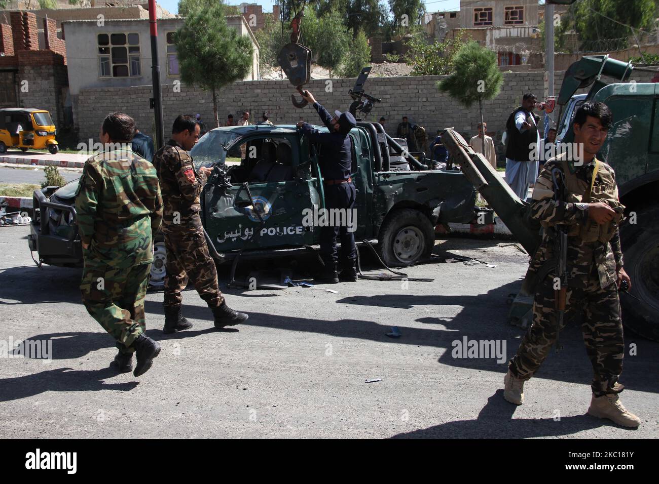 Afghan security force members inspect the site of a car bomb attack that targeted Laghman provincial governor's convoy, in Mihtarlam, Laghman Province on October 5, 2020. At least eight people were killed and 36 others wounded after a car bomb blast rattled Mehtarlam city, capital of Afghanistan's eastern Laghman province on Monday, local Official confirmed. (Photo by Wali Sabawoon/NurPhoto) Stock Photo