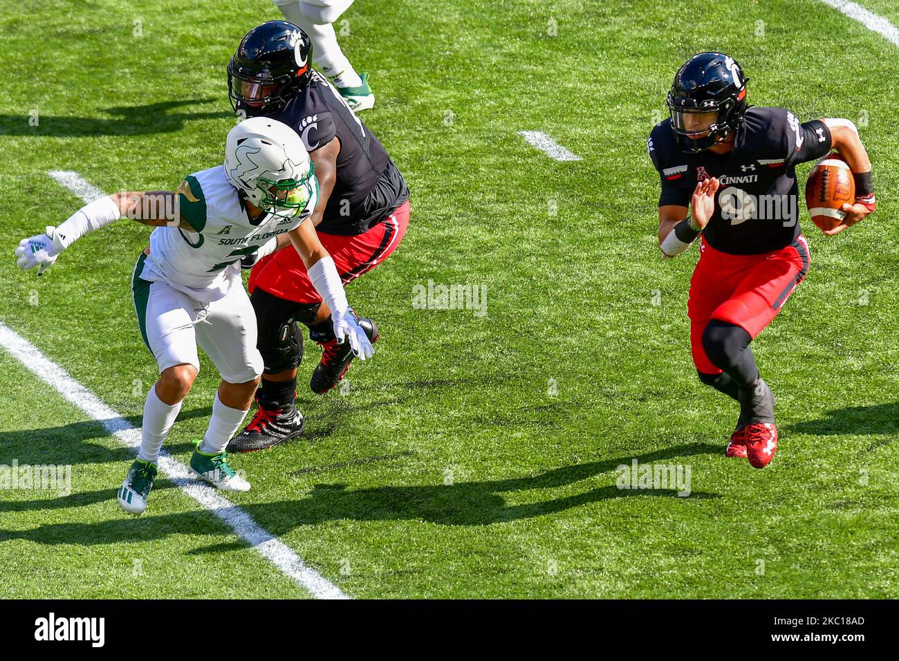 UC quarterback Desmond Ridder (9) runs the ball upfield during an NCAA ...