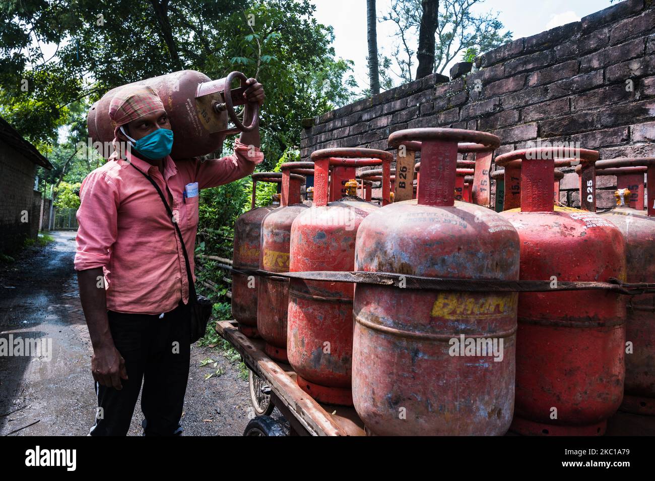 A worker carries a cooking gas cylinde in Tehatta, Nadia, West Bengal, India on October 7, 2020