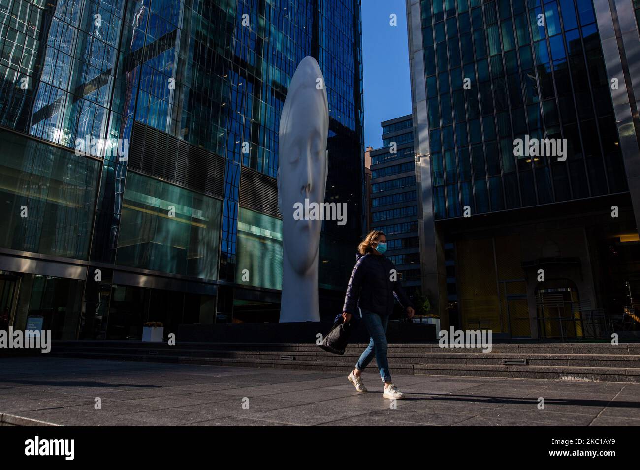 People pass by the new optical illusion installation, "Dreaming" by