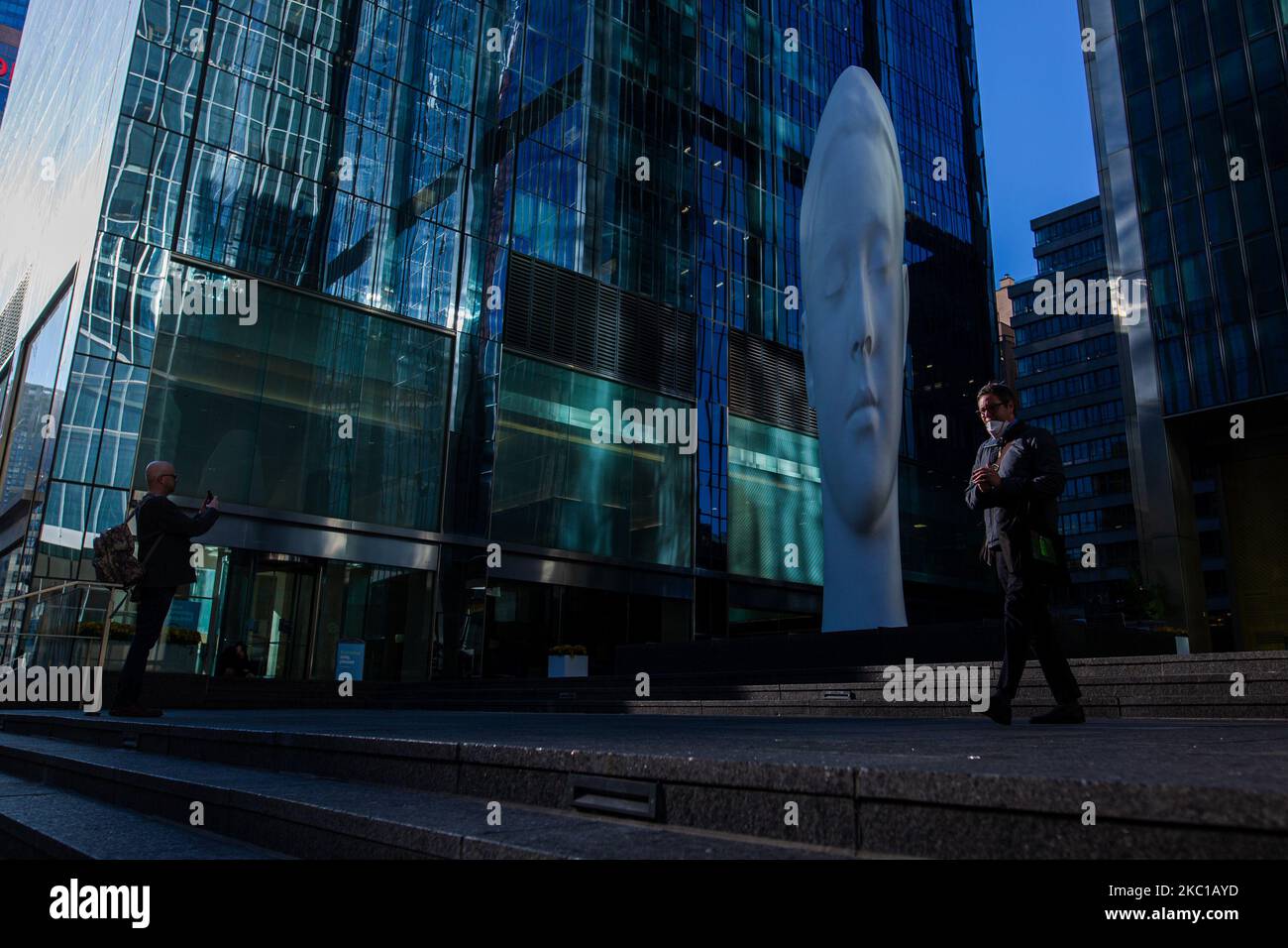 People pass by the new optical illusion installation, "Dreaming" by