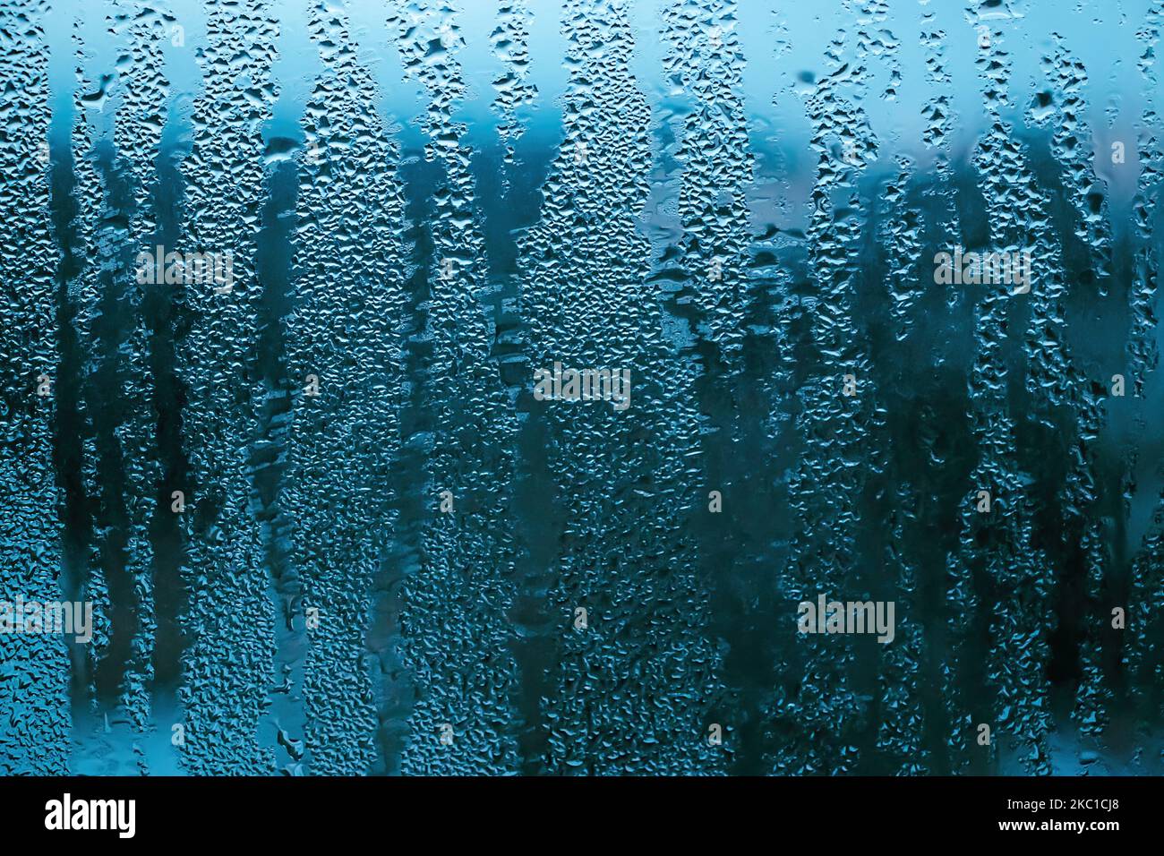Texture of misted glass in autumn. Drops of water on window in rainy weather. Abstract background. Stock Photo