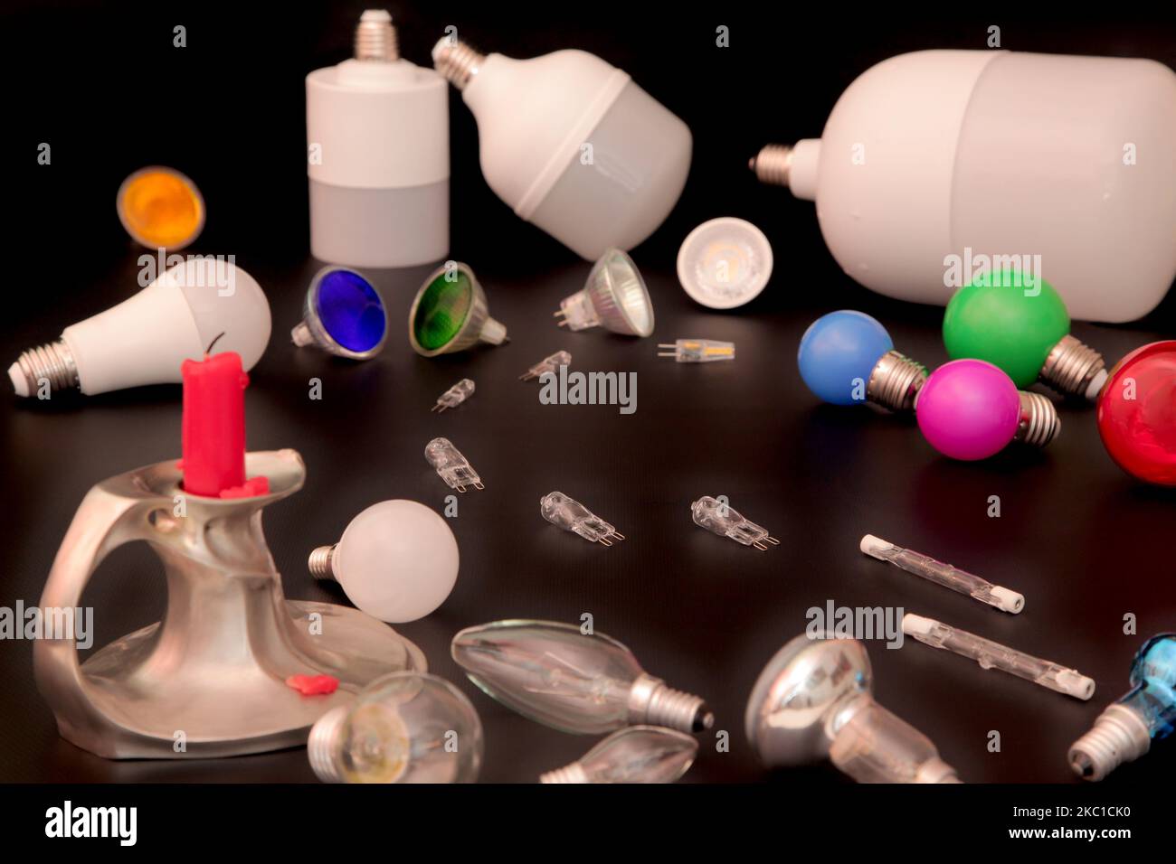 The still life illustrates the changes from candle to halogen lamps. Candle, incandescent lamps