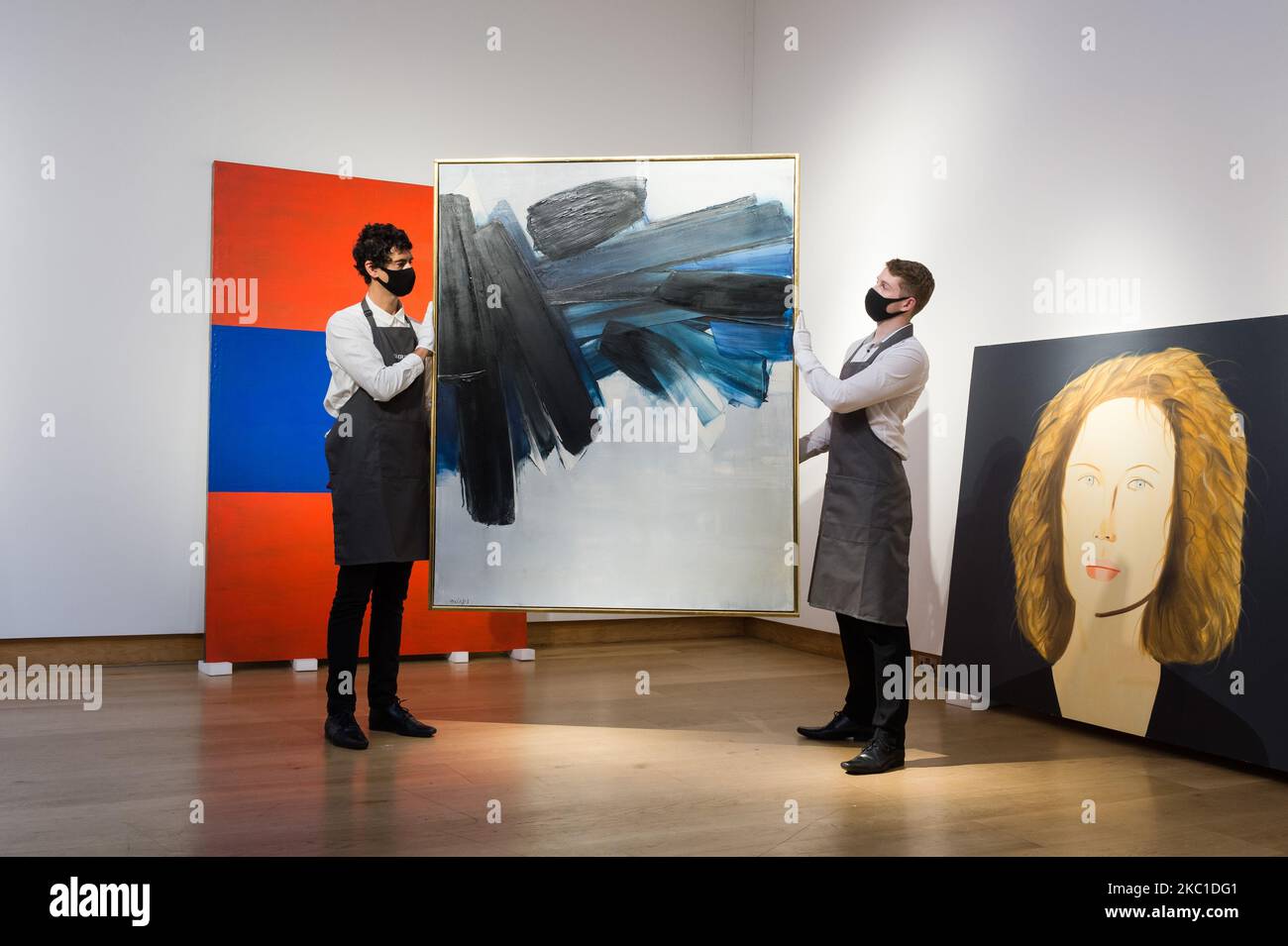 Staff members present Peinture 162 x 130 cm, 9 juillet 1961 by Pierre Soulages (est. €6,000,000-8,000,000) during a photo call for 20th Century: London to Paris sale series at Christie's on October 09, 2020 in London, England. The new sale series, jointly presented by Christie’s London and Christie’s Paris, celebrating the best in Impressionist, modern, post-war and contemporary art and design will take place on 22 and 23 October. (Photo by WIktor Szymanowicz/NurPhoto) Stock Photo