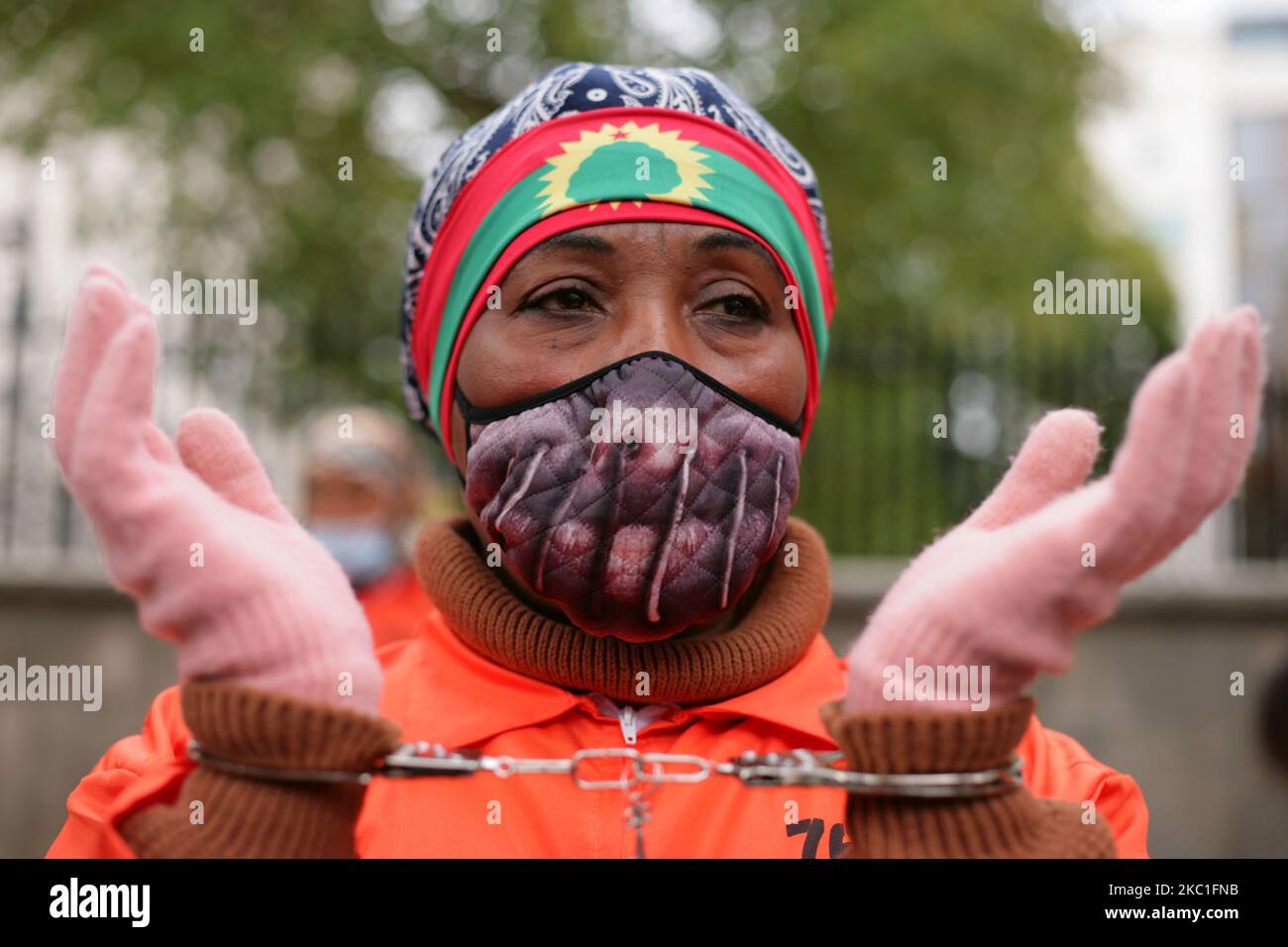 Activists in prison jumpsuits and handcuffs protest human rights abuses against the Oromo people of Ethiopia at a demonstration opposite Downing Street on Whitehall in London, England, on October 10, 2020. (Photo by David Cliff/NurPhoto) Stock Photo