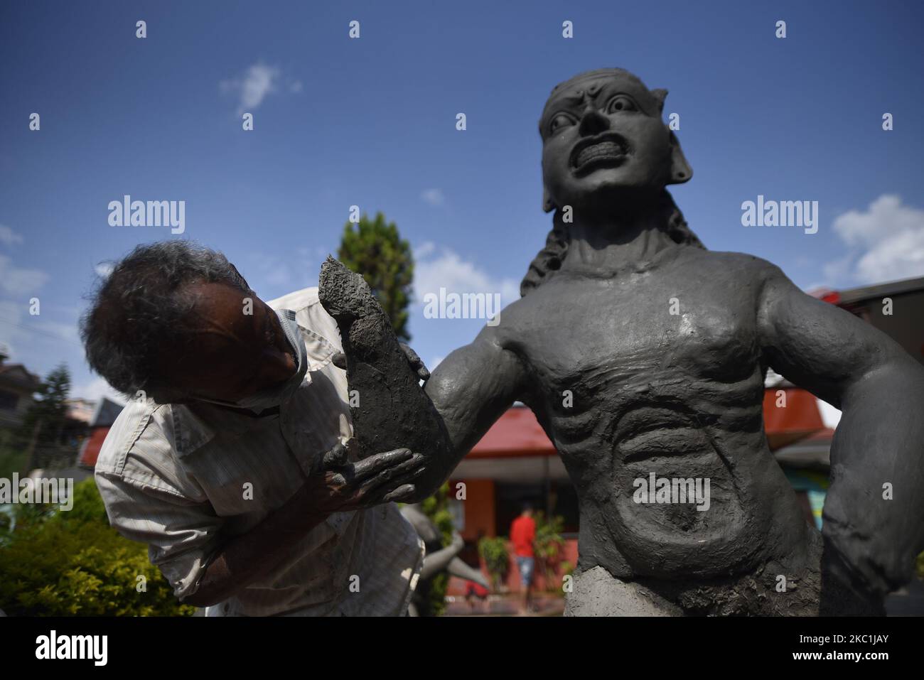 Mathmadus Demon An indian artist making a clay statue of Hindu demon Mahishasura at ...