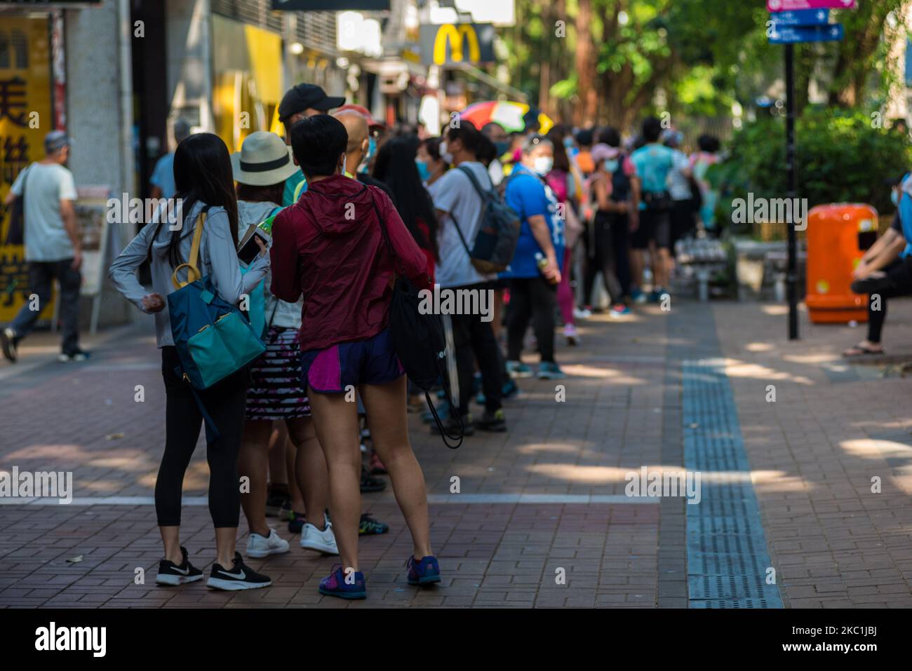 A long queue of people await a bus in Sai Kung in Hong Kong, China, on 11 October 2020. (Photo by Marc Fernandes/NurPhoto) Stock Photo