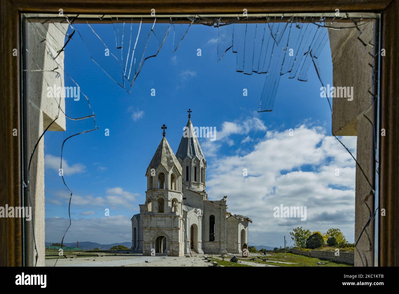 View from a broken window of a building near the Shushi cathedral, Ghazanchetsots Cathedral, after Azerbaijan shelling that destroyed part of roof in a double attack on October 11, 2020. (Photo by Celestino Arce/NurPhoto) Stock Photo