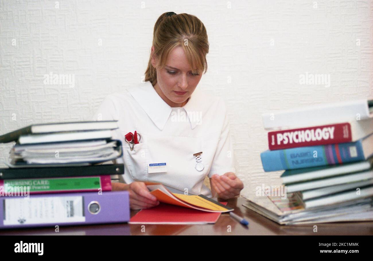 1990s, wearing a white nursing top, watch on chain and badge, a young