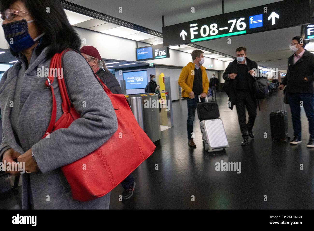 Passengers wearing facemasks, face shields, gloves and other safety measures are seen in the airport terminal, at the F Gates area of Vienna International Airport VIE LOWW - Flughafen Wien-Schwechat serving the Austrian Capital but also Bratislava as it is 55km away from the Slovak city during the Covid-19 Coronavirus pandemic era. There is a second wave coming while cases are increasing, facemask become mandatory, social distancing measures and disinfecting hand sanitizer are everywhere while new lockdowns or mini lockdown in specific areas like Greece or partial lockdown like the Netherlands Stock Photo