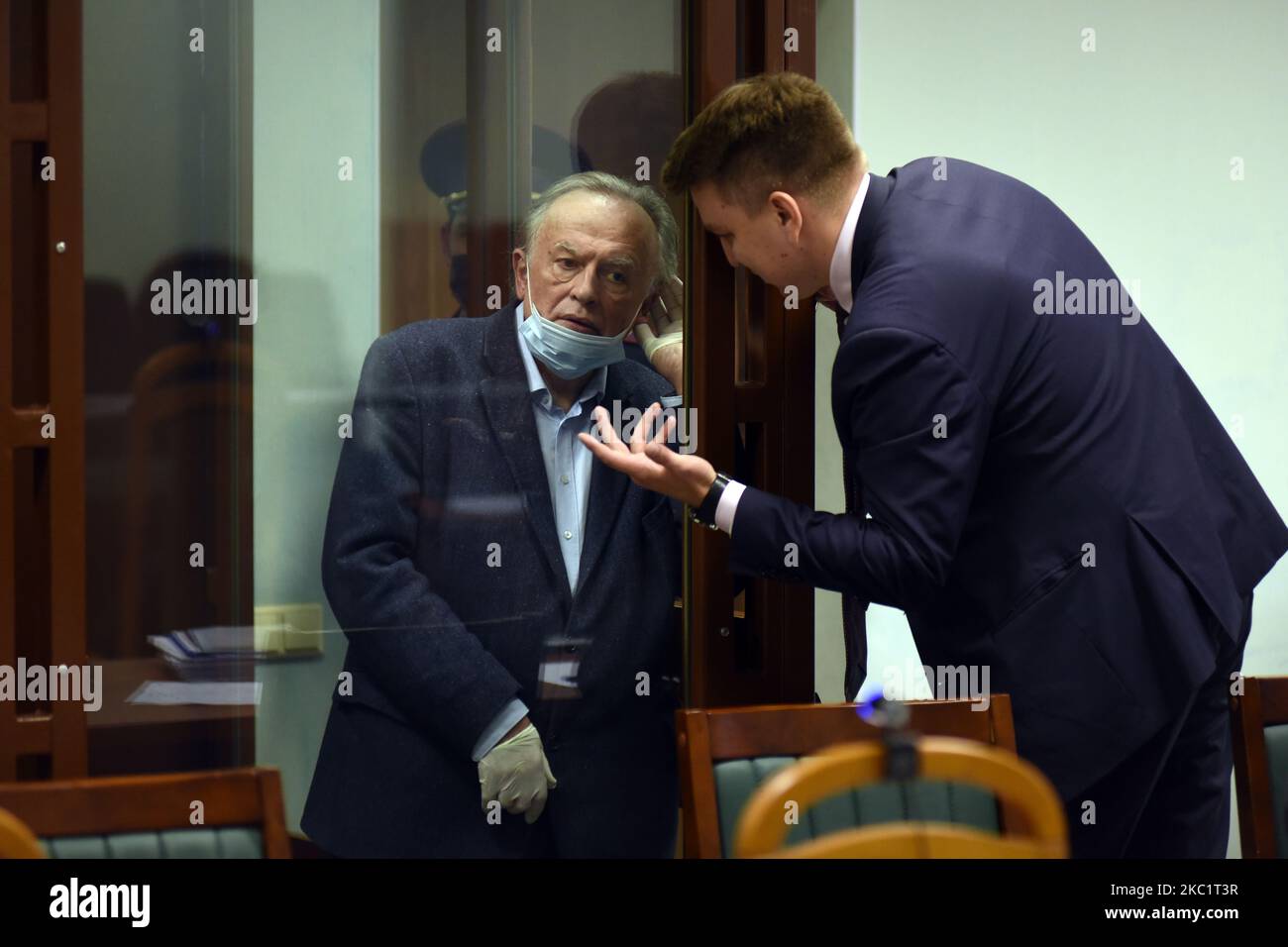 Russian historian Oleg Sokolov, who is accused of killing his girlfriend and former student Anastasia Yeshchenko, speaks to his lawyer in a court room in St. Petersburg, Russia on October 14, 2020. (Photo by Sergey Nikolaev/NurPhoto) Stock Photo
