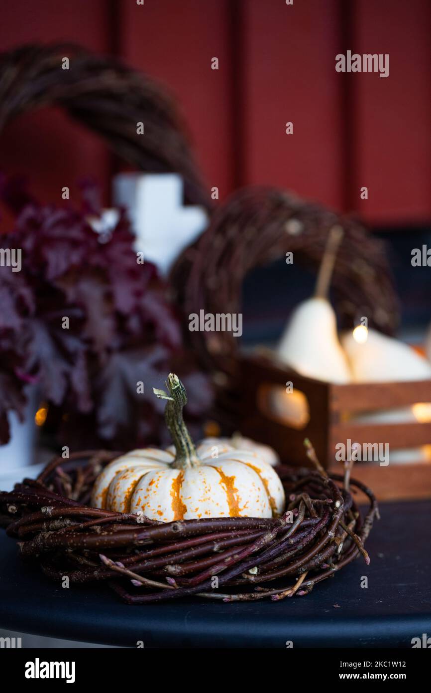 Autumn decorations with pumpkins, lights and wreaths. Front porch decoration. Stock Photo