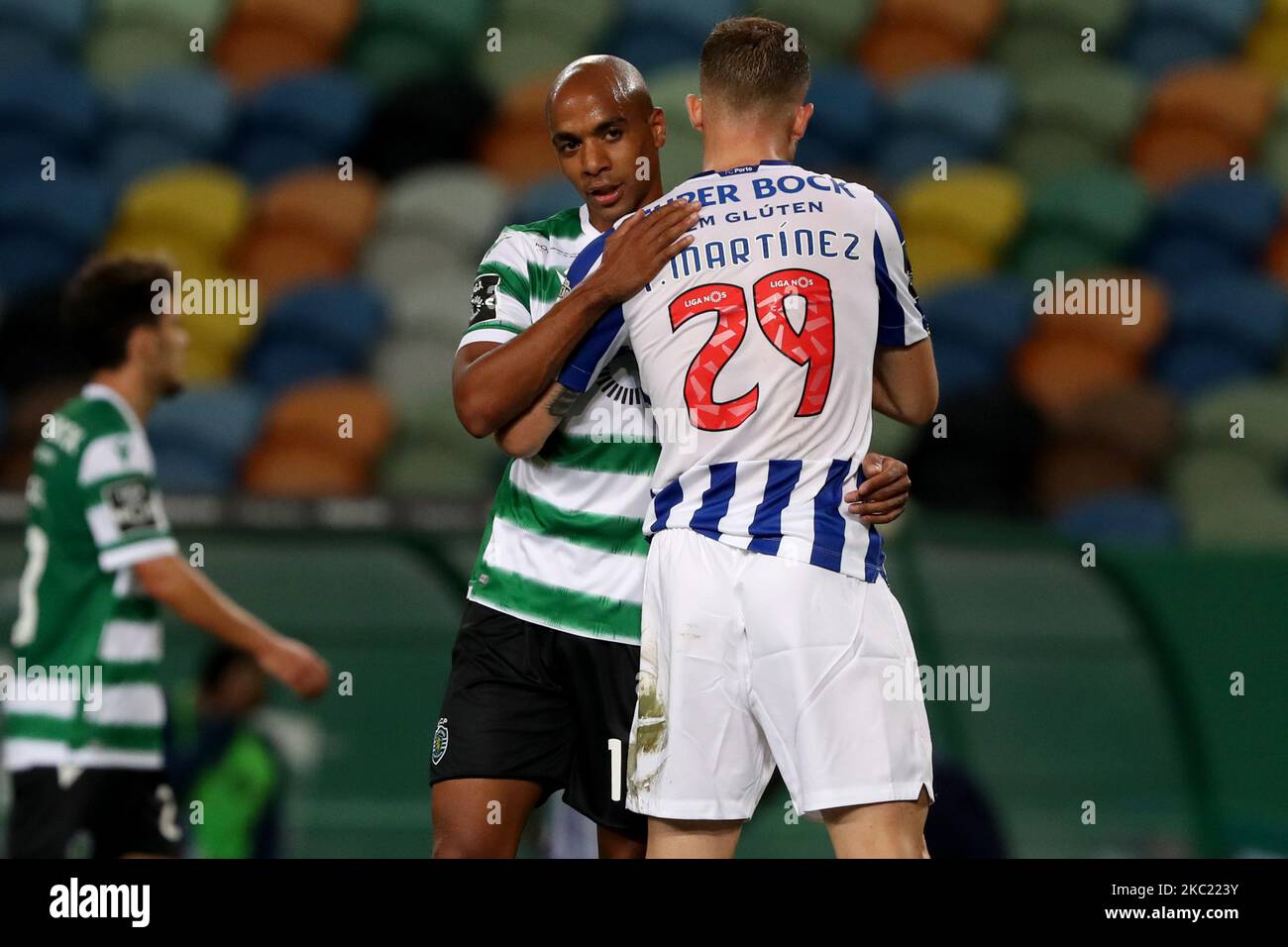 Joao Mario of Sporting CP (L) hugs Toni Martinez of FC Porto at the end of the Portuguese League football match between Sporting CP and FC Porto at Jose Alvalade stadium in Lisbon, Portugal on October 17, 2020. (Photo by Pedro FiÃºza/NurPhoto) Stock Photo
