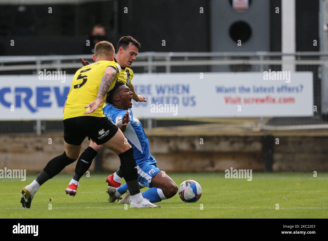 Kgosi Ntlhe of Barrow goes down in the penalty area after a challenge for Harrogate Town's Will Smith and Connor Hall uring the Sky Bet League 2 match between Harrogate Town and Barrow at Wetherby Road, Harrogate, England on 17th October 2020. (Photo by Mark Fletcher/MI News/NurPhoto) Stock Photo
