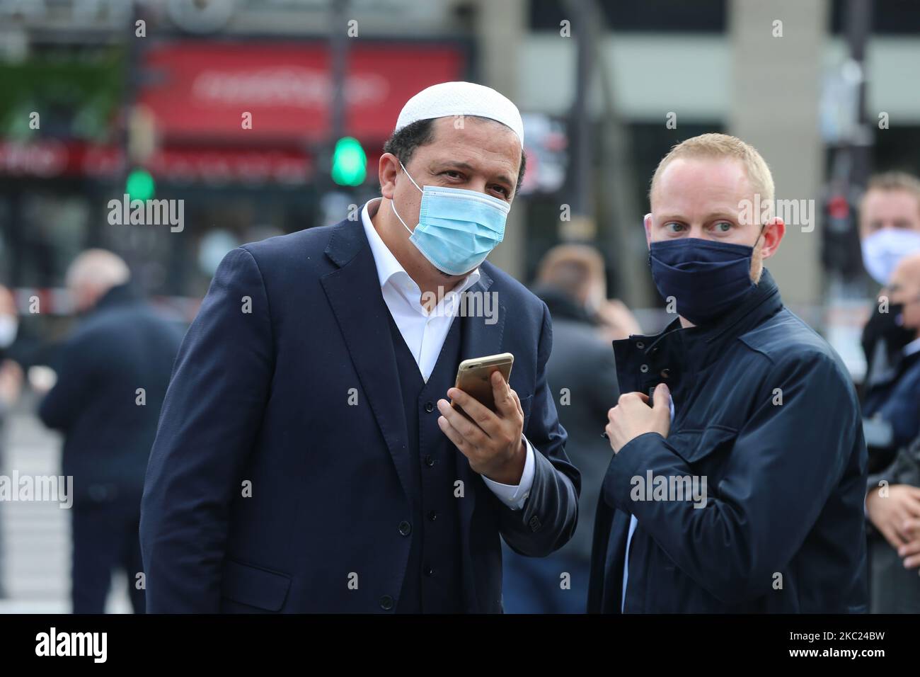 Imam of Drancy Hassen Chalghoumi (L), stand as people gather on Place de la Republique in Paris on October 18, 2020, in homage to history teacher Samuel Paty two days after he was beheaded by an attacker who was shot dead by policemen. Thousands of people rally in Paris and other French cities on October 18 in a show of solidarity and defiance after a teacher was beheaded for showing pupils cartoons of the Prophet Mohammed. His murder in a Paris suburb on October 16 shocked the country and brought back memories of a wave of Islamist violence in 2015. (Photo by Michel Stoupak/NurPhoto) Stock Photo
