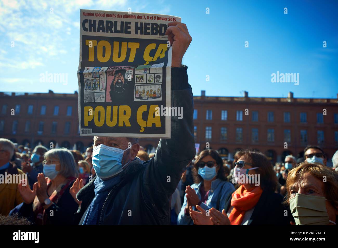 A man shows a cover of Charlie Hebdo newspaper reading 'All that for this'. After the killing of Samuel Paty, teacher of Geography-History, in Conflans-Sainte-Honorine (Yvelines) on October 16th several thousands of people gathered on the main square of Toulouse, in front of the townhall, the Capitole, to defend freedom of expression and to pay tribute to Samuel. Some people came with a cover of Charlie Hebdo as the teacher has been killed after showing at his pupils the Charlie Hebdo' caricatures of Muhammed. The killer has been killed by French police afterwards. On October 18th, 2020 in Tou Stock Photo