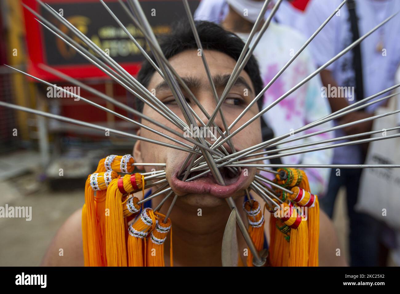 (EDITORS NOTE: Image contains graphic content.) Thai devotees are possessed by spirits and pierced with long needles during a Vegetarian ritual at the Sapam Shrine on October 19, 2020 in Phuket, Thailand. The annual Phuket vegetarian Festival will be held from October 17th to 25th. Also known as the Nine Emperor Gods Festival, devotees participating in the festival abstain from eating meat, drinking alcohol, and there to other requirements during the duration of the festival. Spirit mediums known as man song are believed to become possessed with benevolent spirits, going into a trace and takin Stock Photo