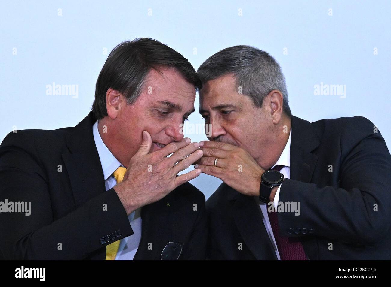 Brazil's President Jair Bolsonaro speaks with Brazil's Chief of Staff Minister Walter Souza Braga Netto during the COVID-19 Clinical Study result announcement at the Planalto Palace in Brasilia, Brazil, on October 19, 2020. (Photo by Andre Borges/NurPhoto) Stock Photo
