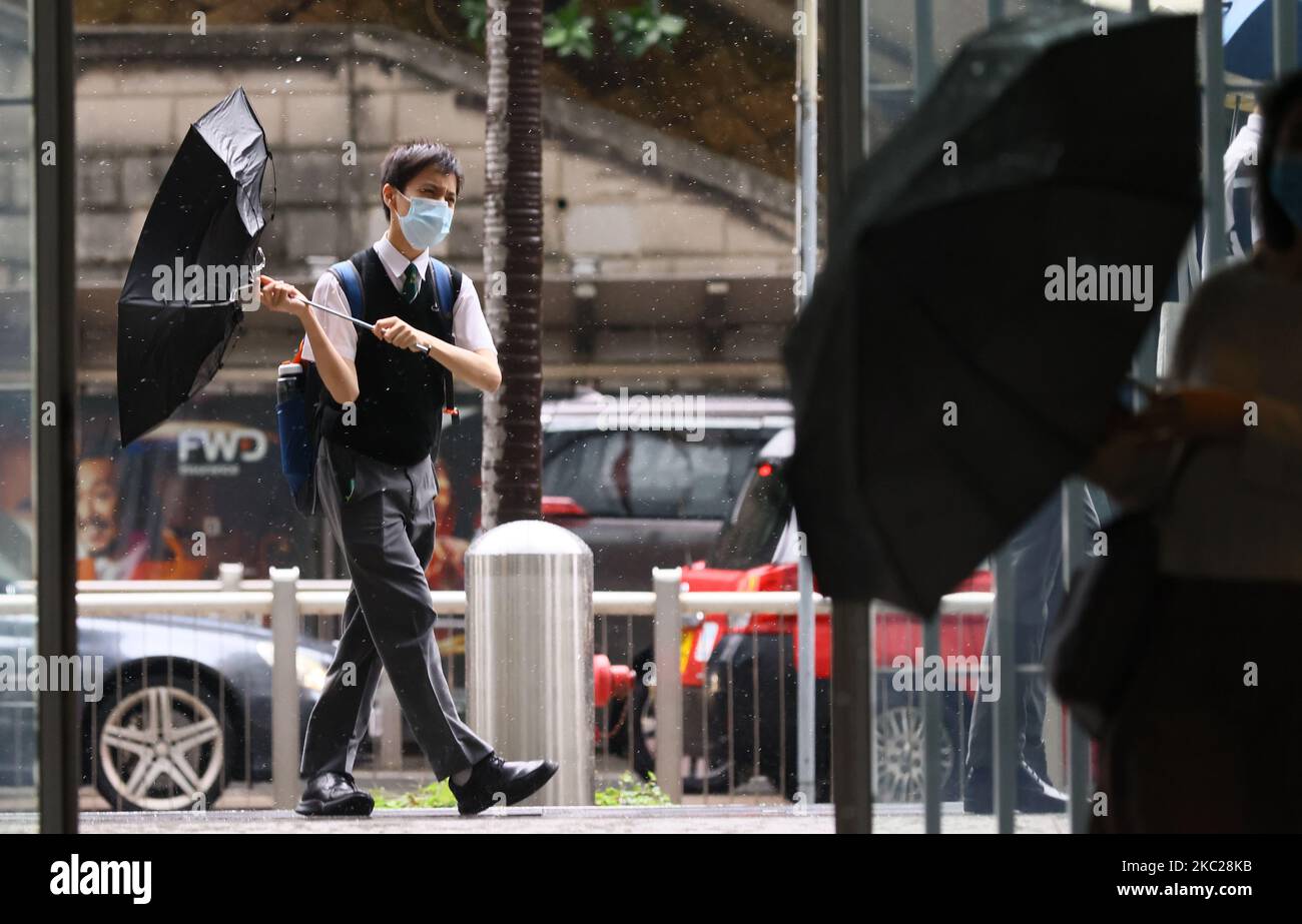 Pedestrian in Central brave the winds and rain as the Hong Kong ...